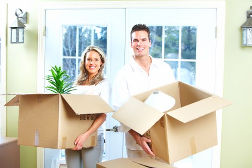 Removal van outside a Spanish home with movers handling boxes
