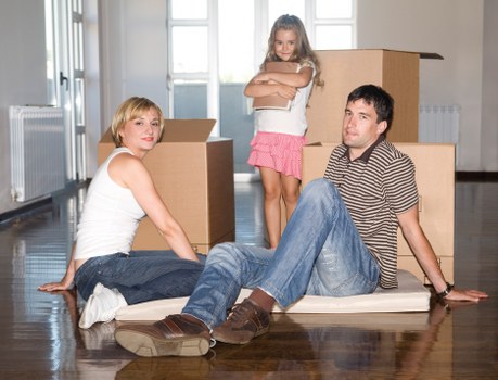 Local movers organizing boxes in a Spanish property